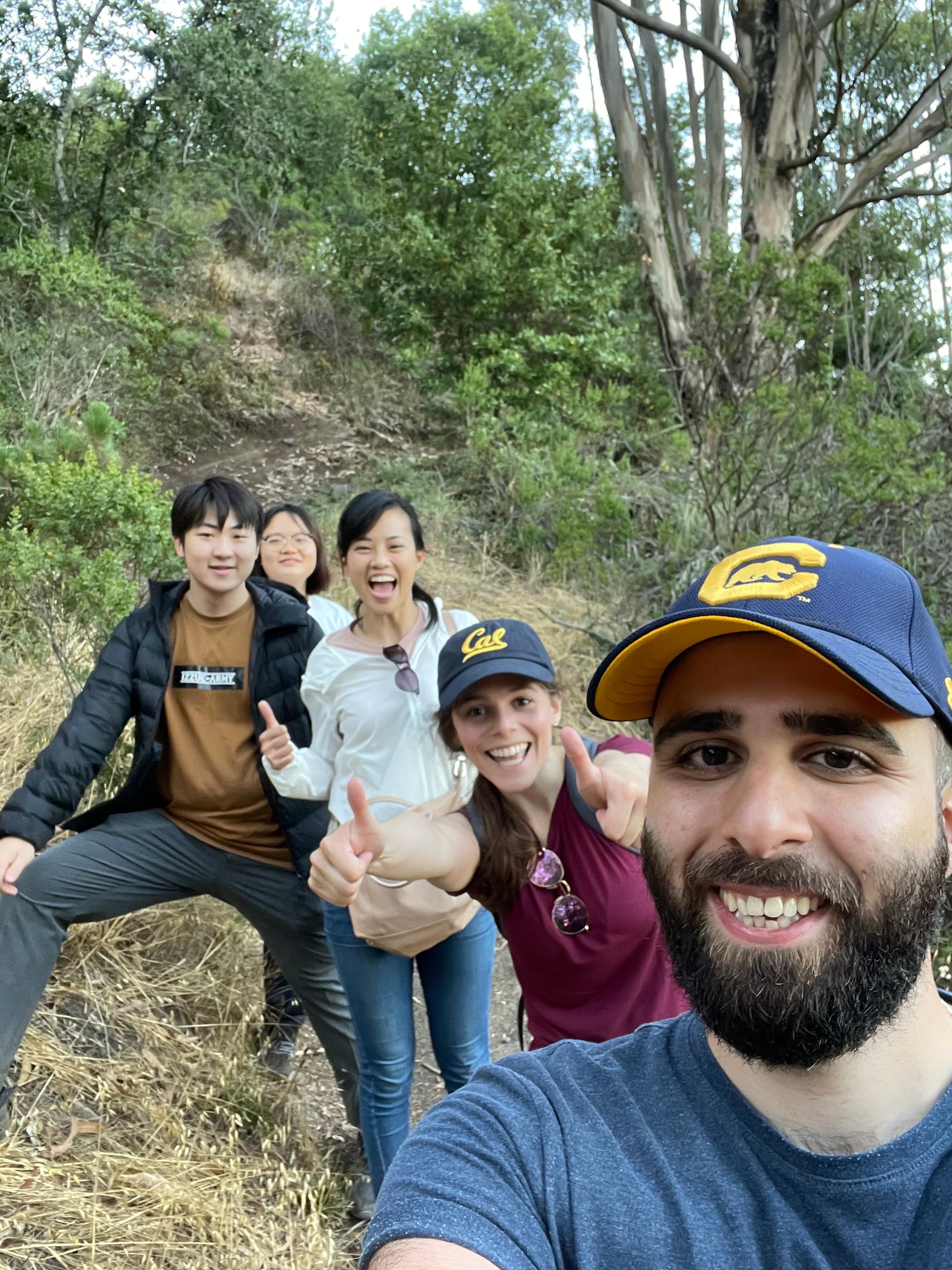 Smiling people posing for group selfie during a hike